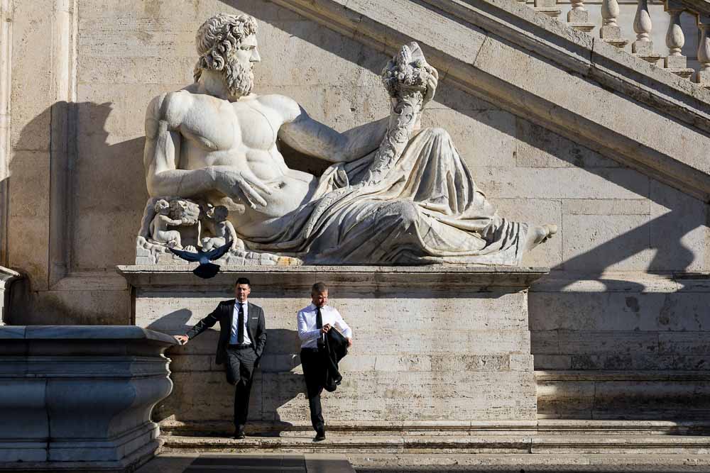 Standing underneath an ancient marble statue in Rome Italy