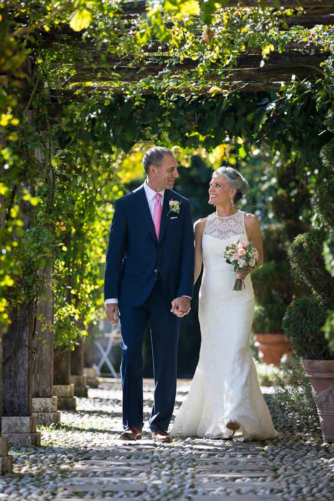 Bride and groom walking together in the villa park. Tuscany Elopement Wedding photography 