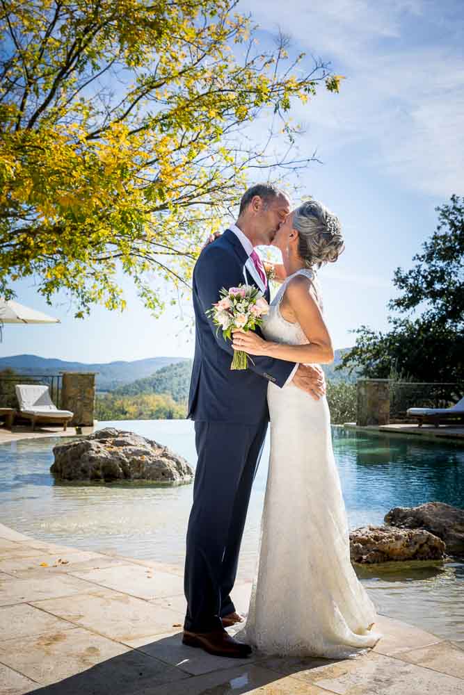 Newlyweds kissing outdoors after marriage