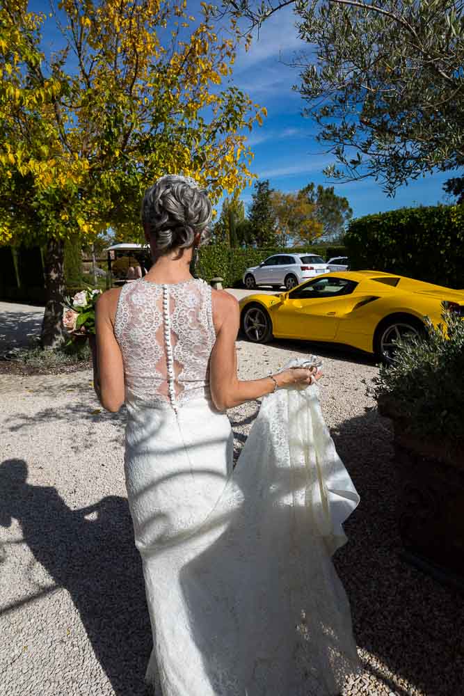 Bride walking and leading to the wedding car