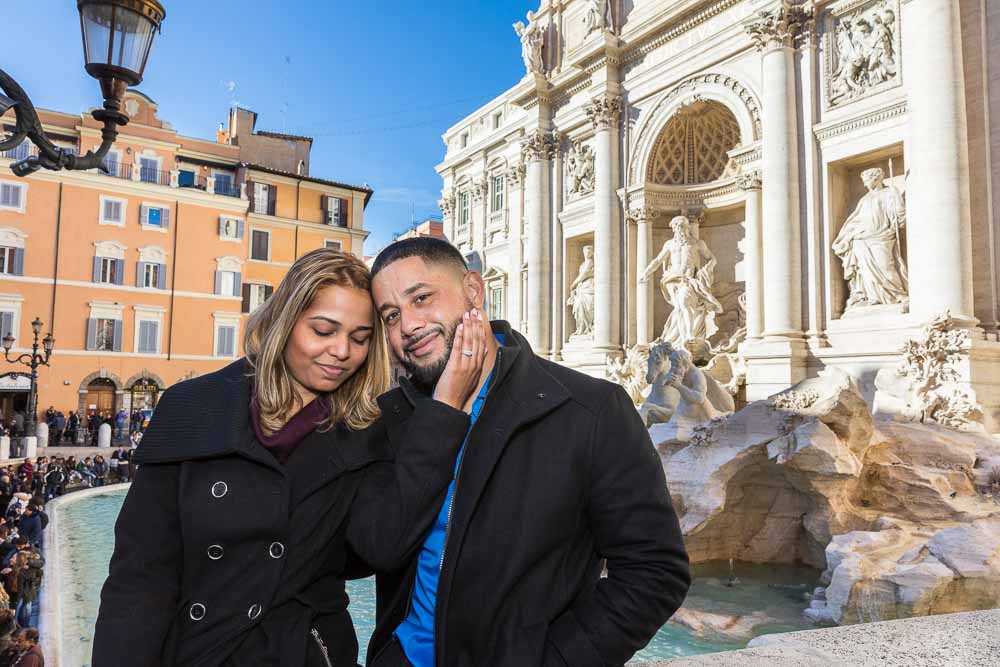 Couple posed close to one another at Fontana di Trevi