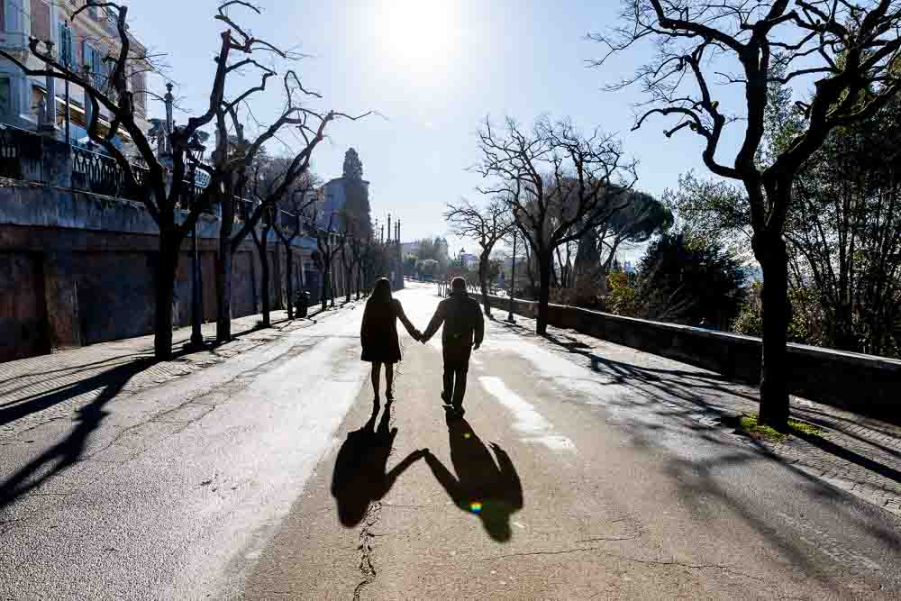 Couple walking away holding hands in silhouette