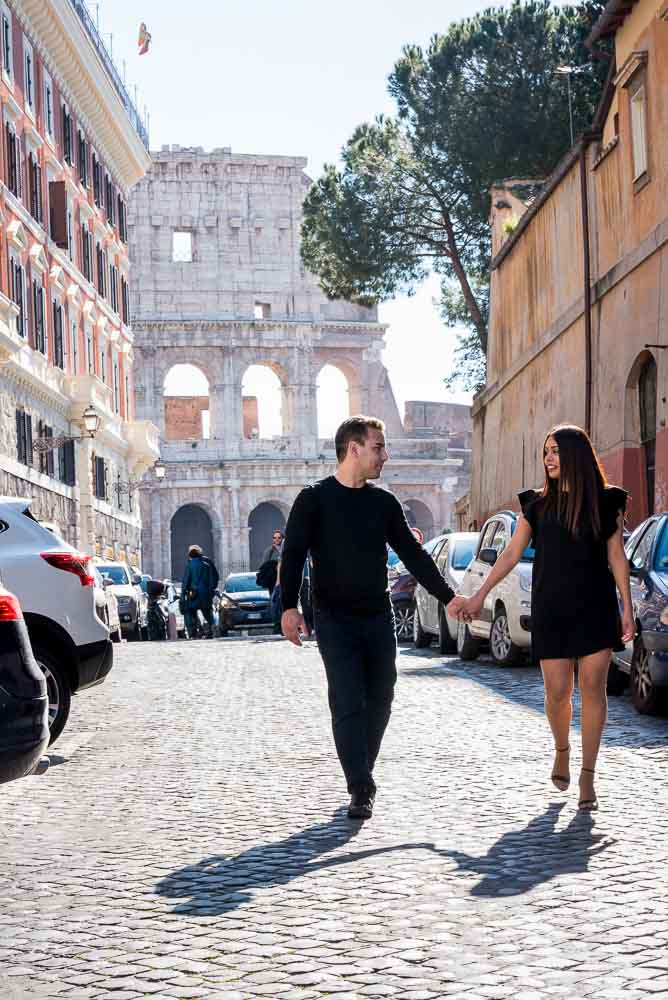 Walking in a roman alleyway with the Coliseum in background