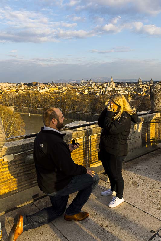 Proposal in Rome on top of the Castel Sant'Angelo terrace candidly photographed from a distance by a professional photographer