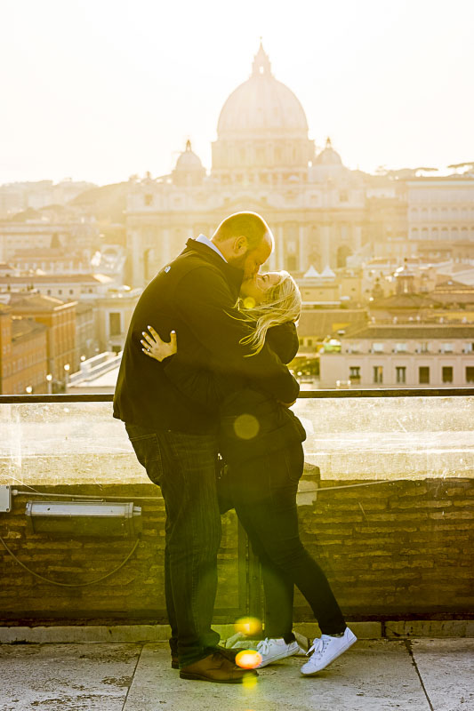 Kissing at sunset in front of Saint Peter's dome in the far distance