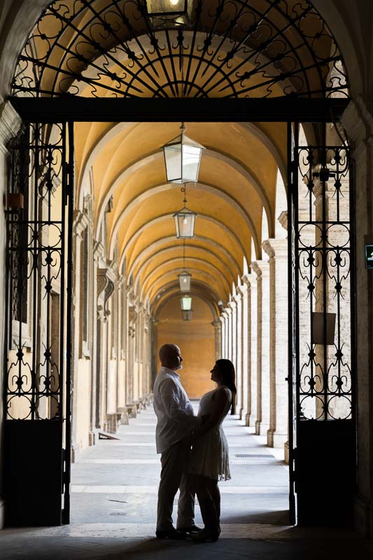 Silhouette image of a couple standing under portico