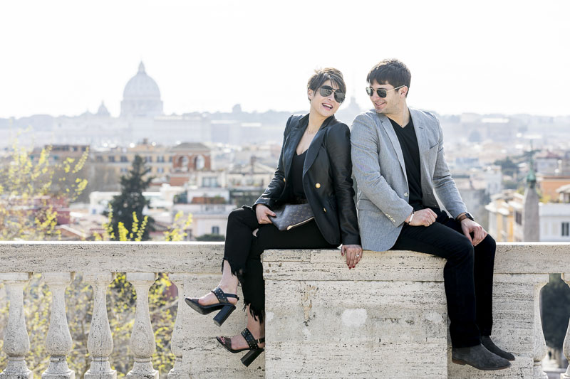 Picture portrait sitting down on a ledge before the Rome cityscape