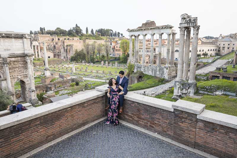 Sitting down pose before the ancient ruins of the old city of Rome