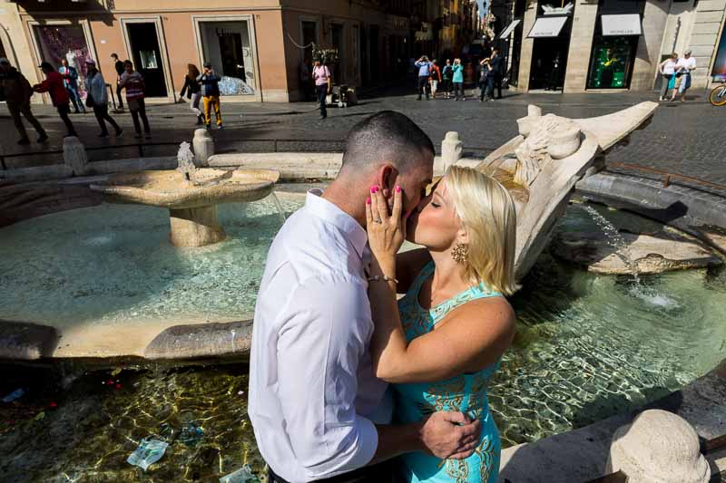 Kissing at the Barcaccia waterfountain in Rome Italy