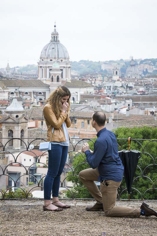 Man knee down Rome Marriage Proposal taking place at the belvedere park terrace overview