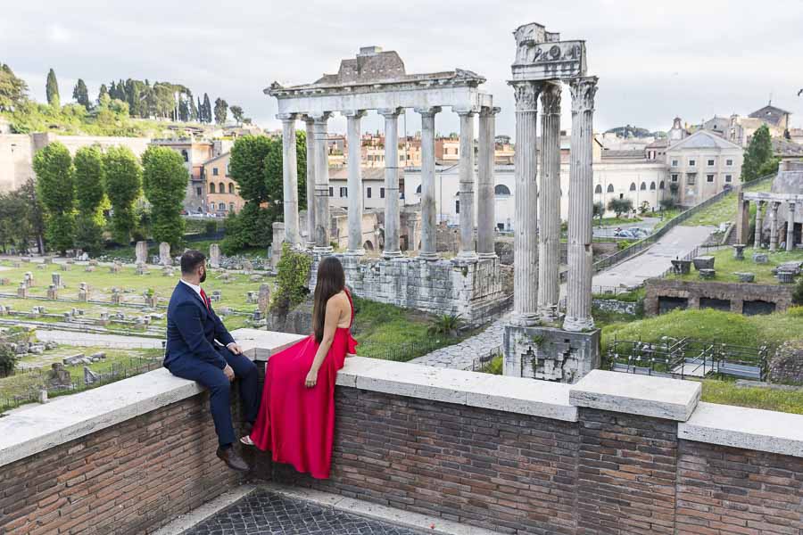 Looking at the ancient roman ruins at the Forum during an engagement photo session