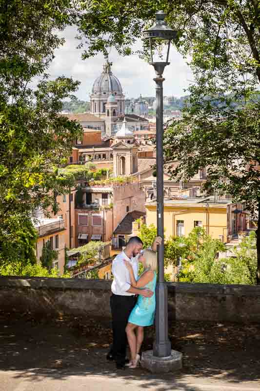 Love story engagement session with the roman rooftops in the far background