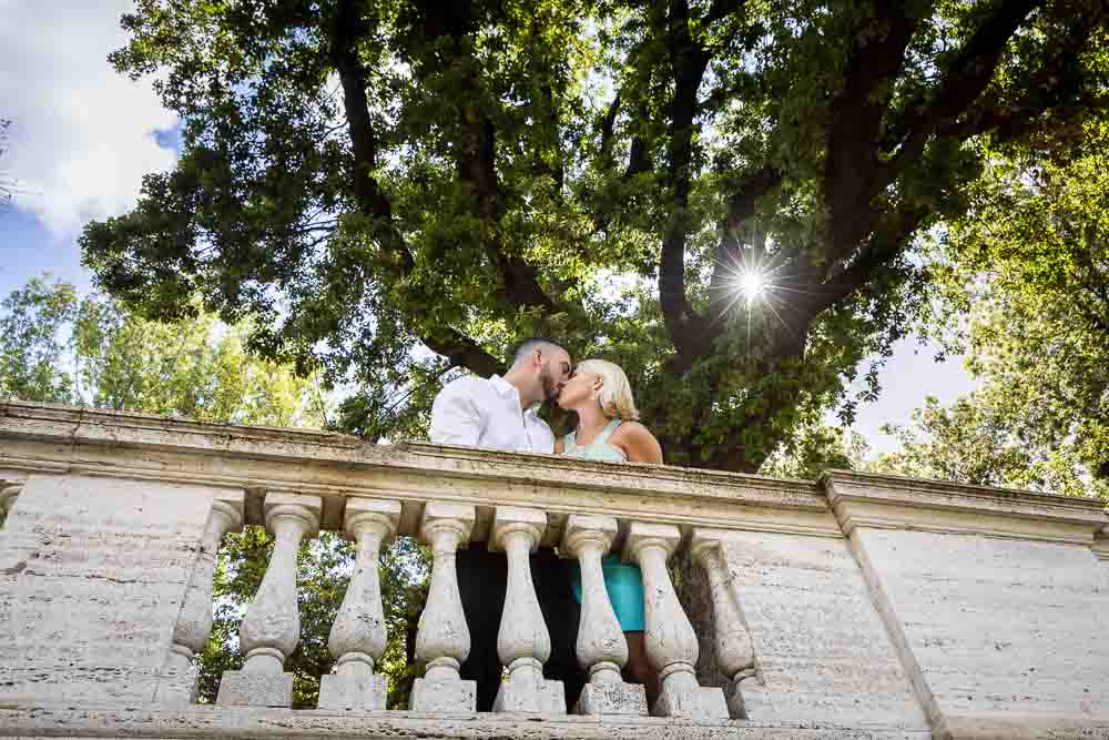 Couple engagement photography session in Italy. Kissing on a balcony.