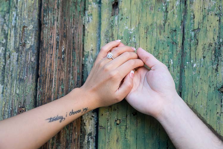 Holding hands showing the engagement ring