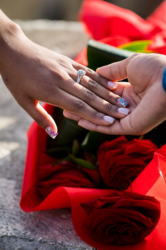 Close up image of the engagement ring over red roses