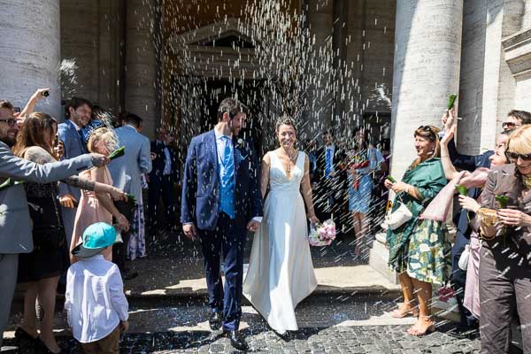 Newlyweds exiting the civil town hall and welcomed by rice throwing