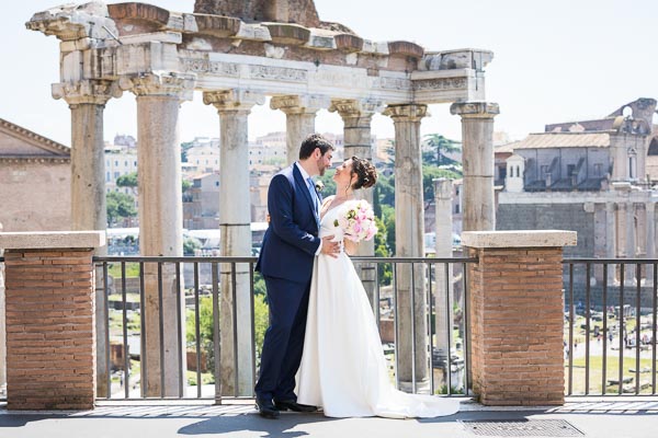 Bride and groom taking pictures before the roman forum in Rome Italy