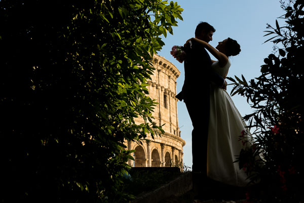 Silhouette image of the couple just married taking pictures in Rome Italy