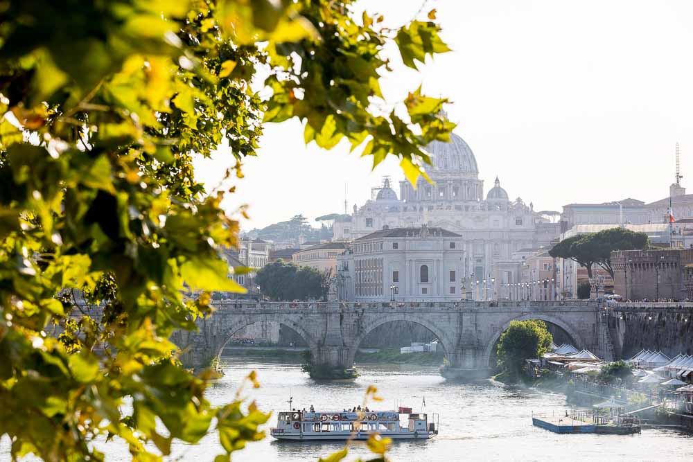 Saint Peter's dome cathedral seen from a nearby bridge at sunset