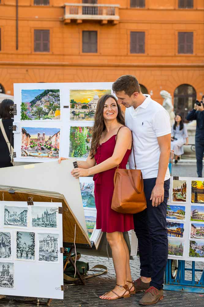 Couple browsing through street paintings