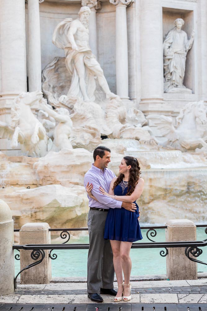 Coupe standing before the beautiful Trevi fountain white marble statues