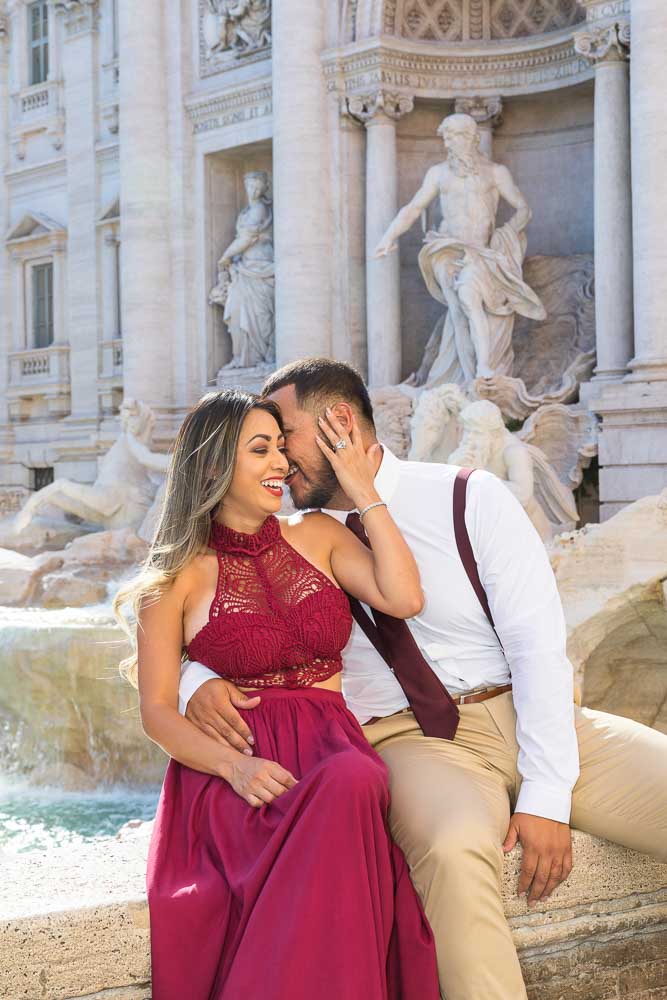 Laughing and kissing while having fun during a couple photo session in Rome