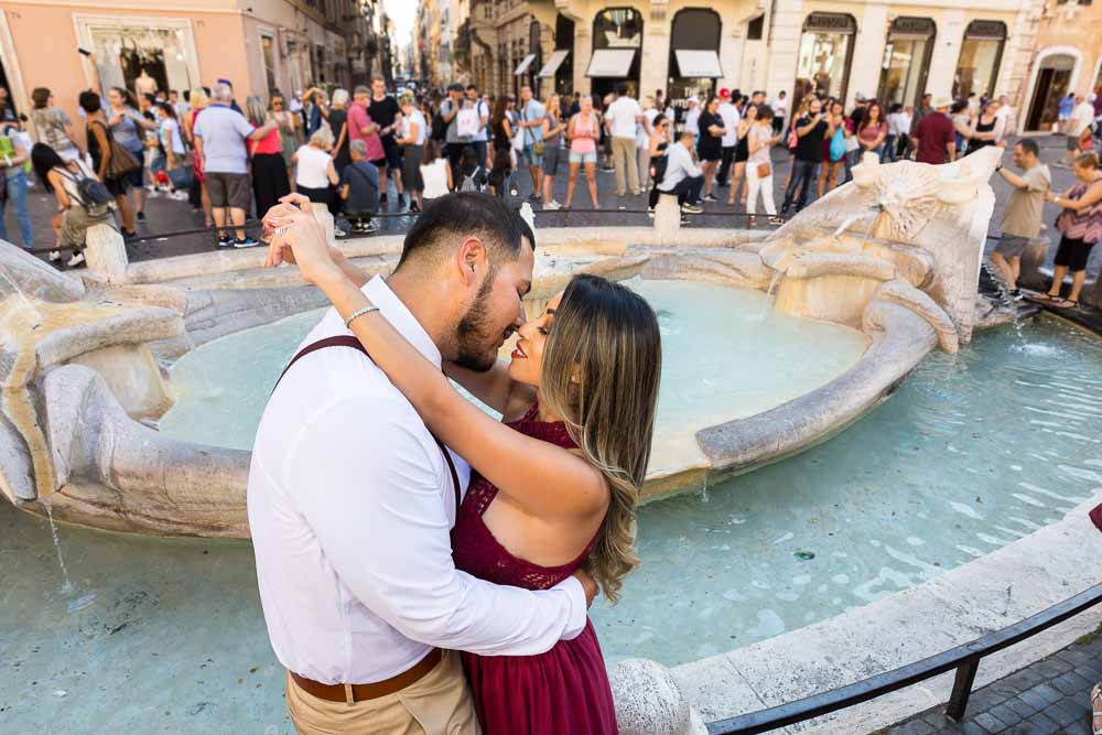 In love in Rome photo shoot by the Barcaccia water fountain found on the bottom of the Spanish steps in Piazza di Spagna Roma
