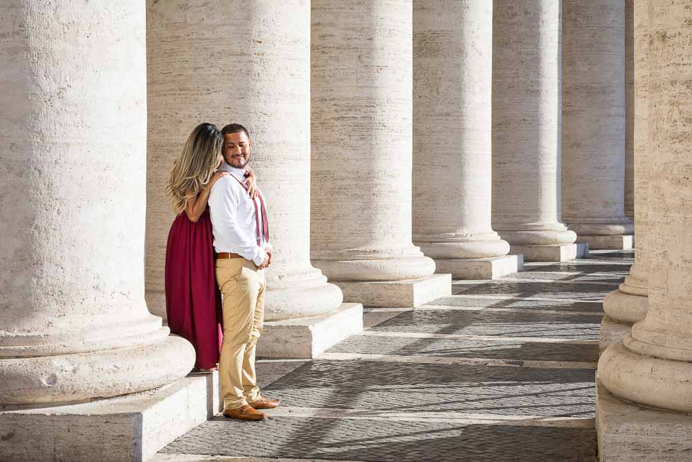 Couple portrait picture among the columns found in the St. Peter's main square