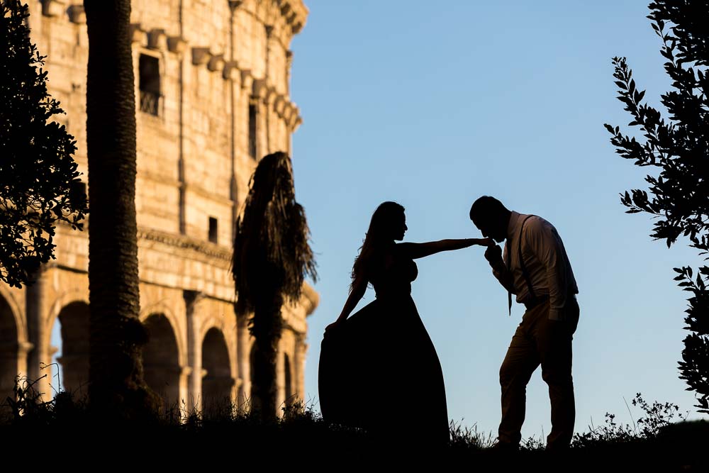 Chivalry at the Coliseum in Rome. Silhouette couple image. Photo taken at dusk after sunset. Blue hour moment