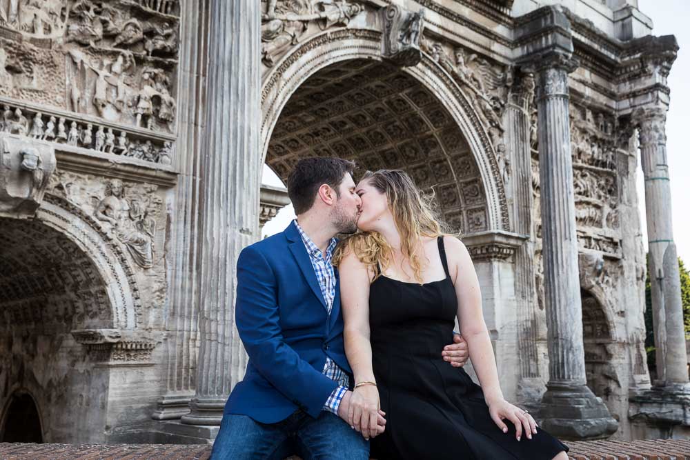 Framed kiss under a roman arc contained in the forum in Rome Italy