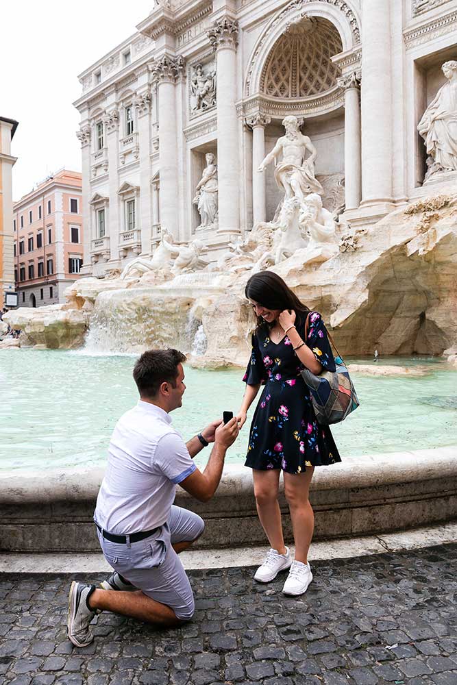 Surprise wedding proposal photographed and video recorded at the Trevi fountain in Rome Italy.