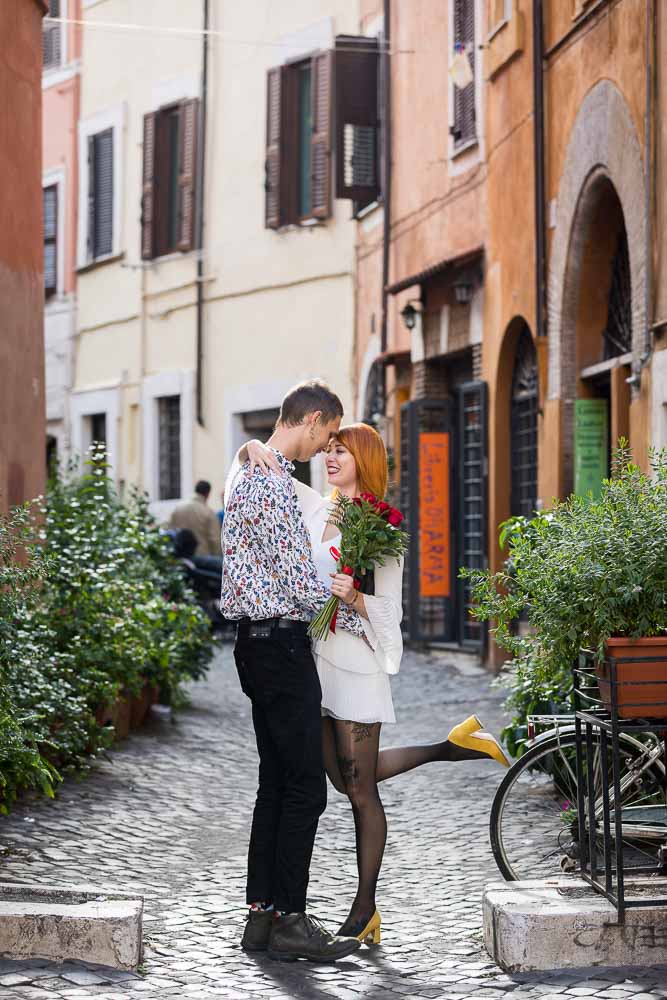 Standing together in the cobble stone alleyway streets in Rome during a photo shoot