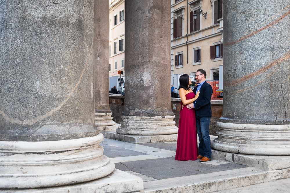 Couple standing underneath the massive Pantheon colonnade during a photography session in Rome