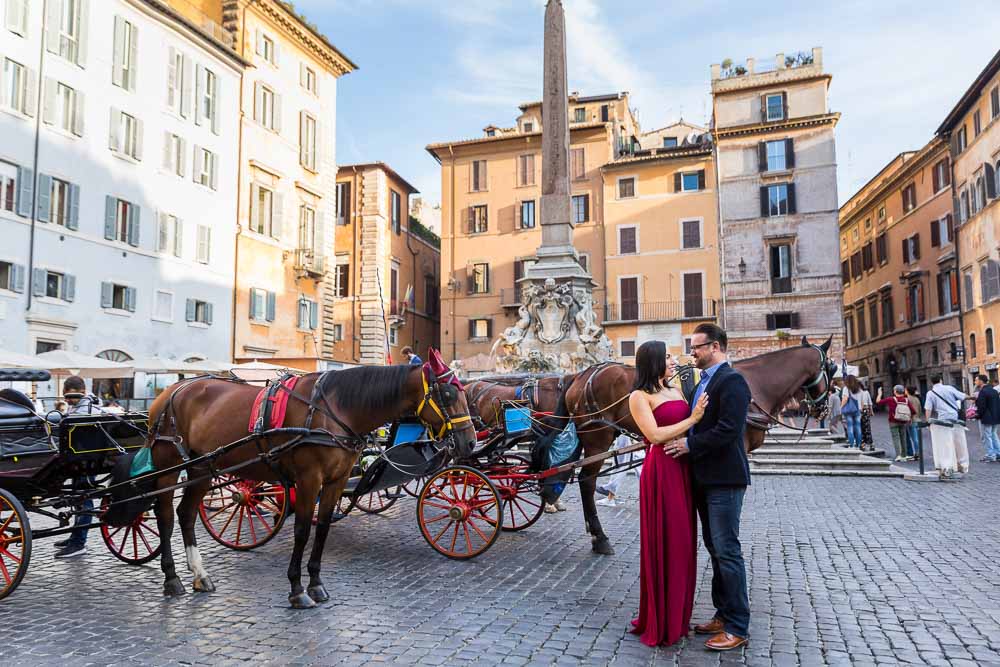 Posing before the Roman Pantheon obelisk in Piazza della Rotonda with the typical parked horse carriages