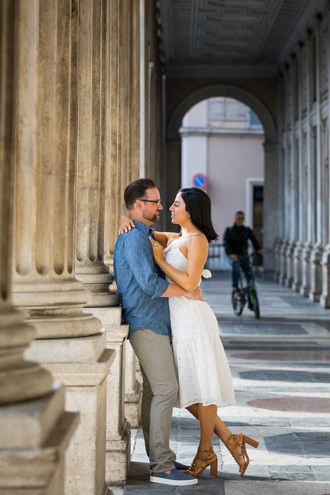 Couple posing underneath columns and arched