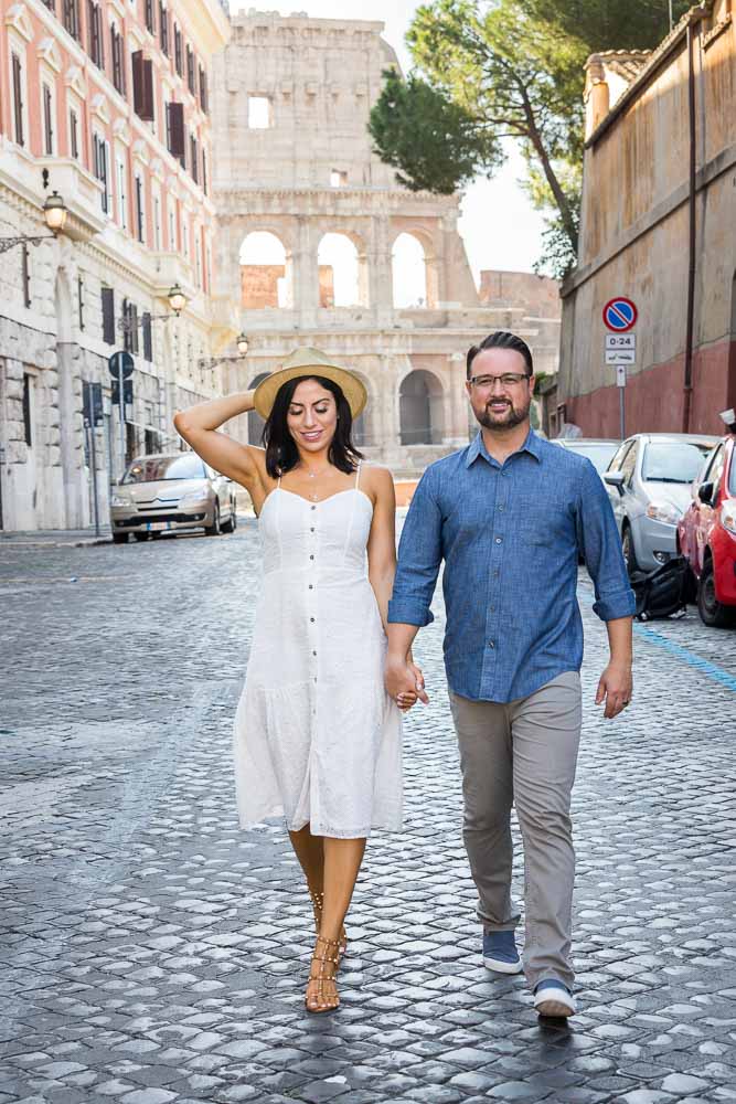 Walking hand in hand at the Coliseum on cobble stone streets