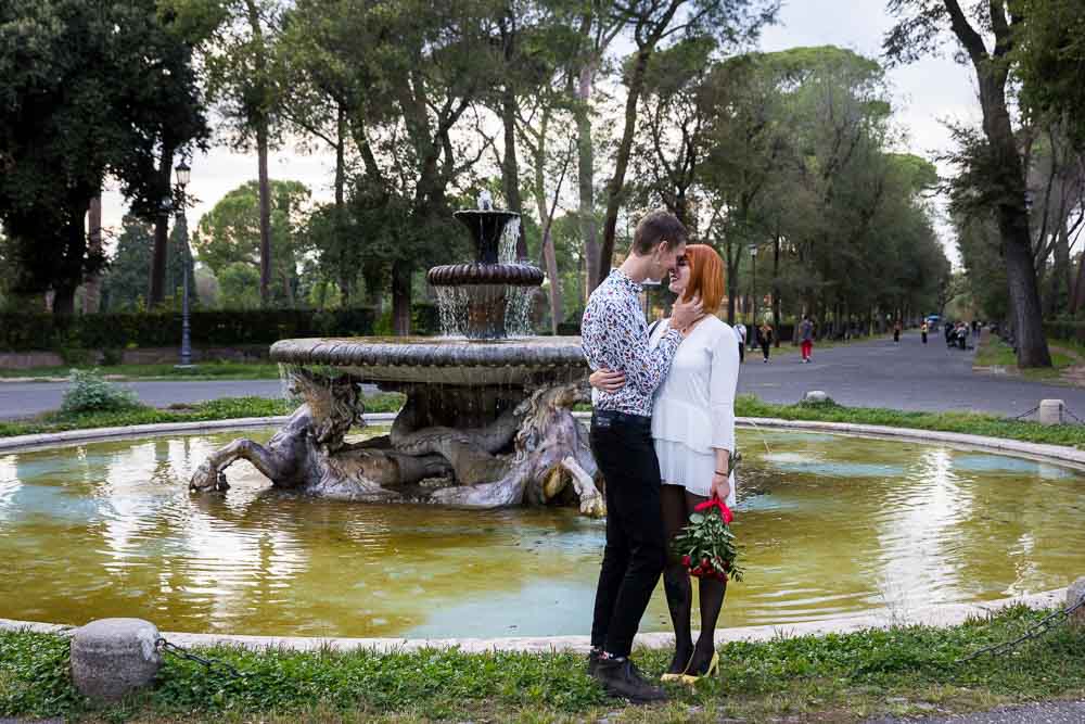 Love and romance close together before a fountain in the Borghese park