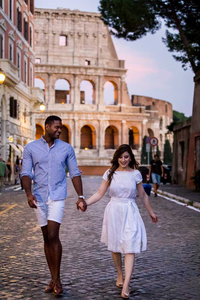 Walking hand in hand while visiting the roman coliseum