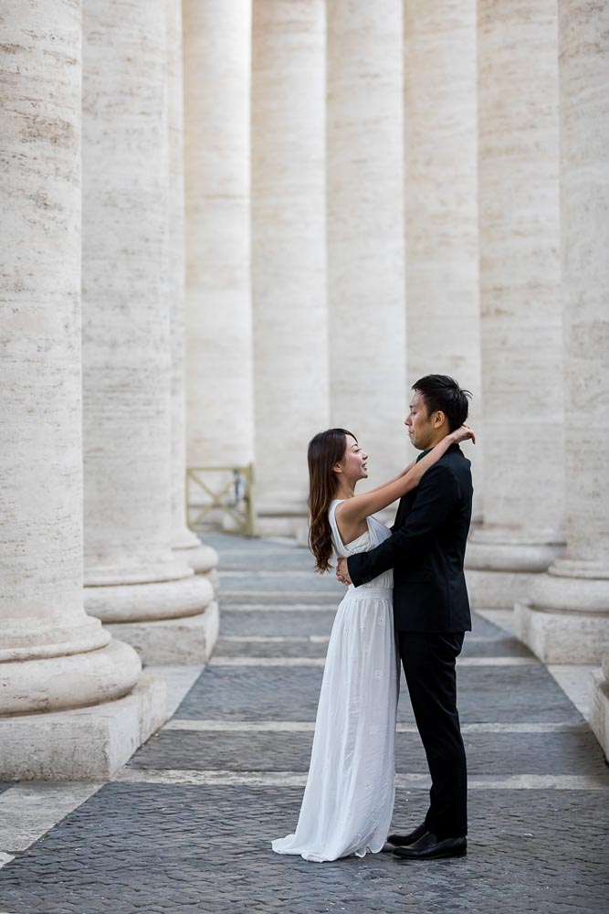 Close together underneath the colonnade of the Vatican's St. Peter's square