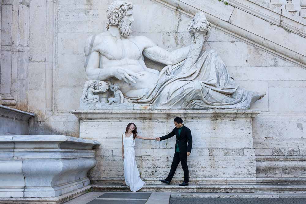 Photo shoot under a large marble statue found in the Campidoglio square
