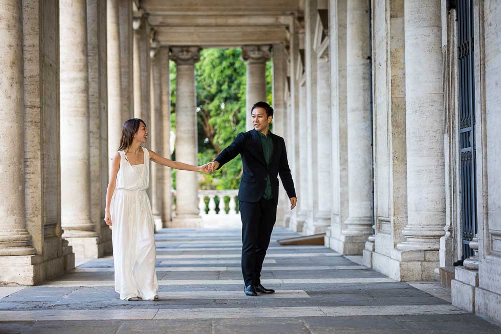 Hand in hand under marble columns