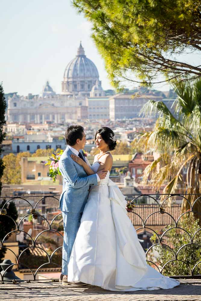 Posing together in front of the sweeping view of Rome and Saint Peter's cathedral in the far distance