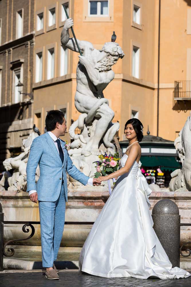 Holding hands while taking photos at the scenic water fountains found in Piazza Navona