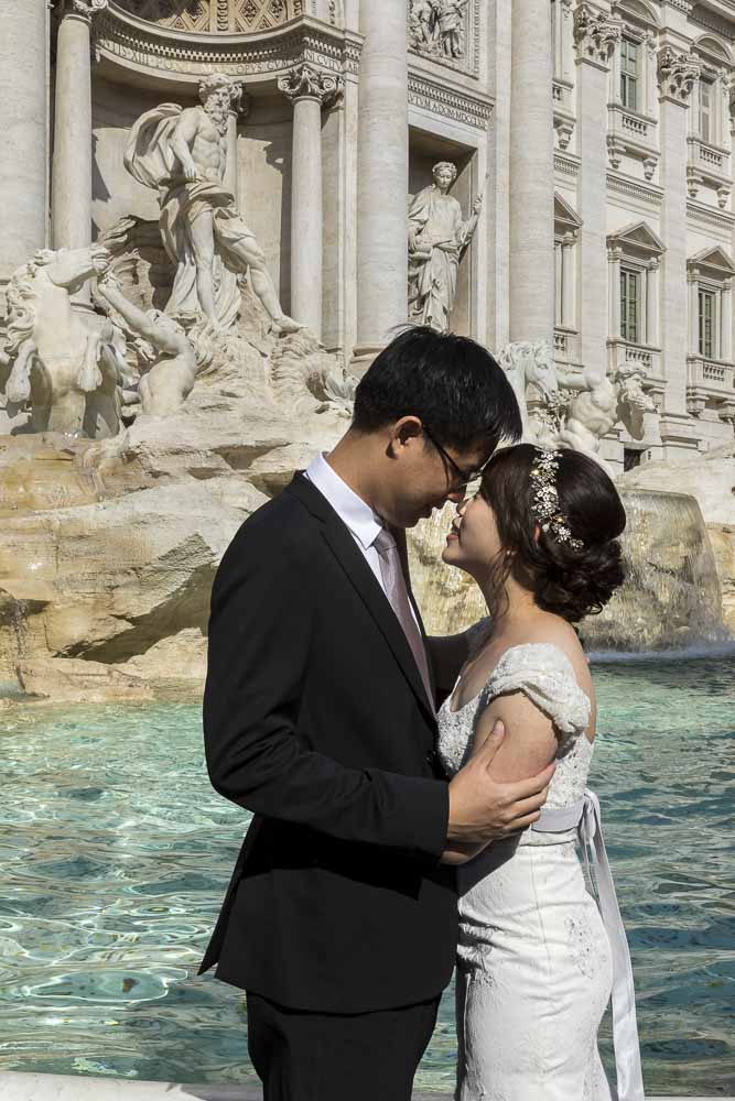 Bride and groom picture portrait photographed at the Trevi fountain in Rome Italy