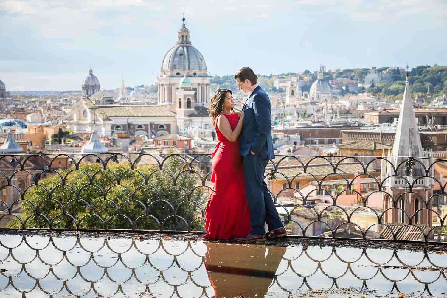 Couple taking photos in front of the sweeping view of the roman city from a nearby hill side view