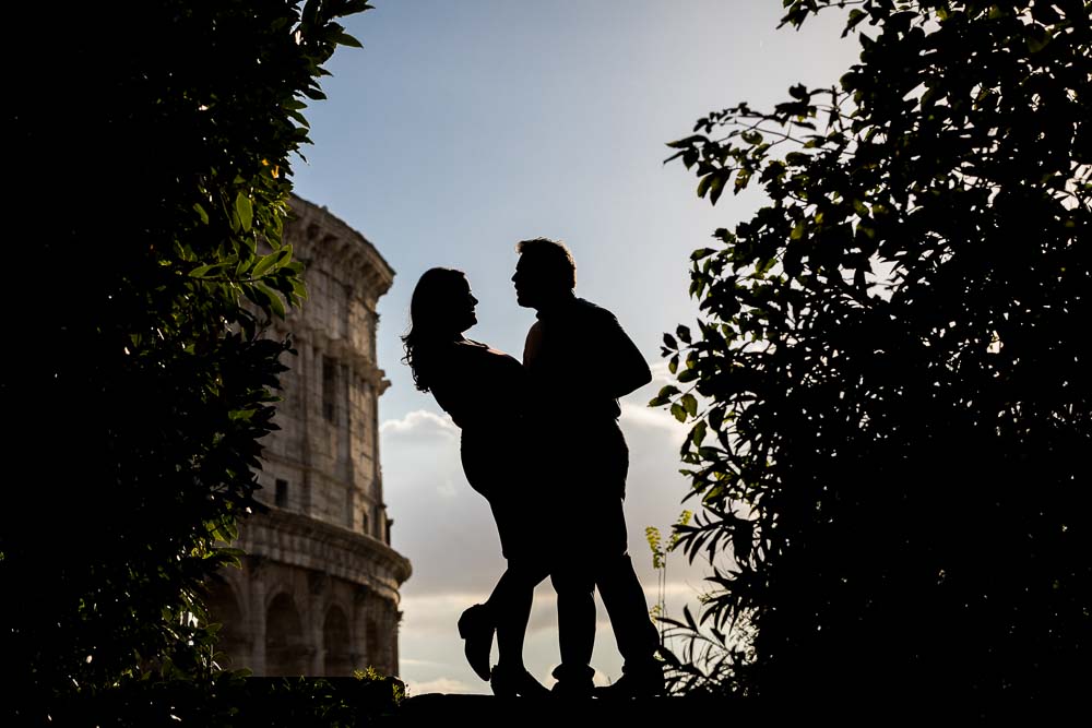 Artistic silhouette image of a couple standing before Rome's colosseum