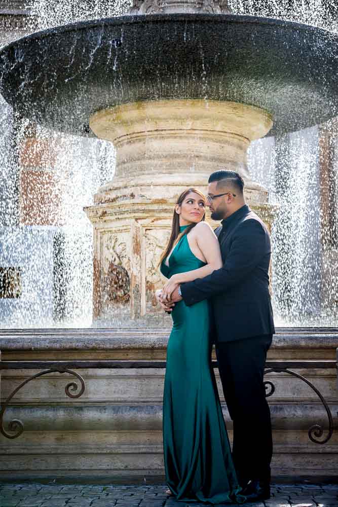 Portriat picture of a couple surrounded by splashing water fountain droplets all around them