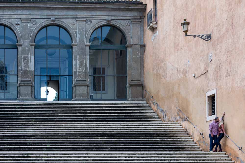 Romance standing on a scenic staircase during a photo session