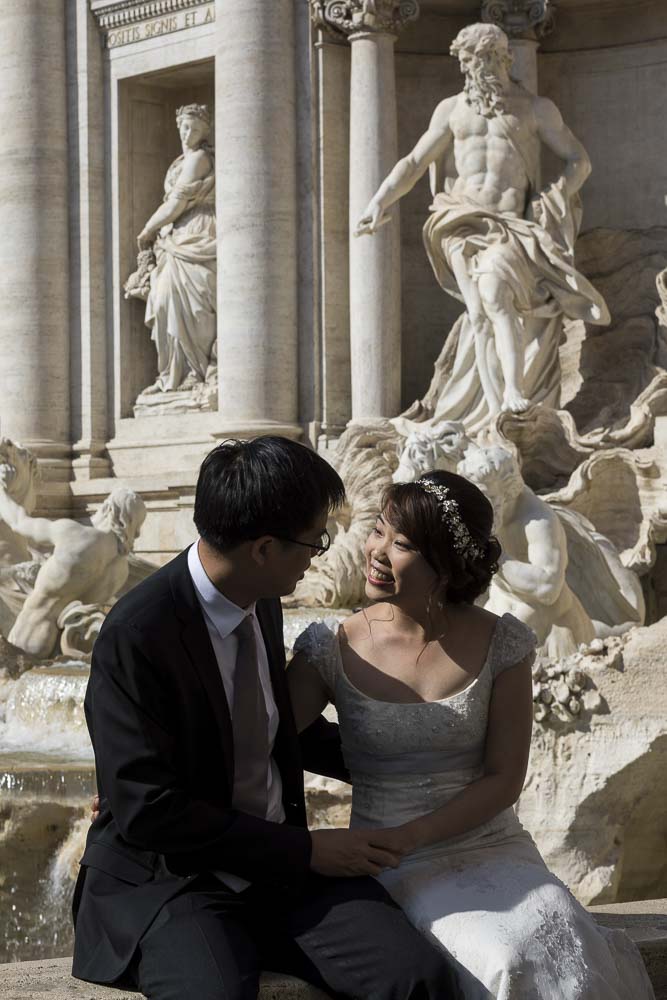 Sitting down portrait image of a wedding couple at Fontana di Trevi