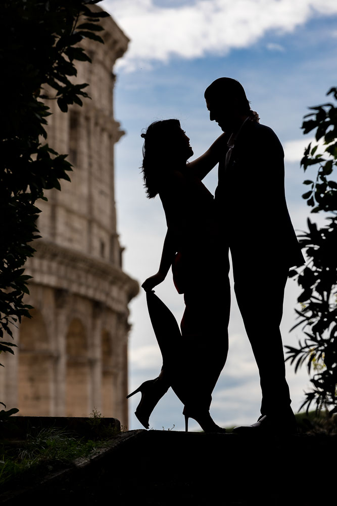 Silhouette image of a couple posing in front of the Roman Coliseum